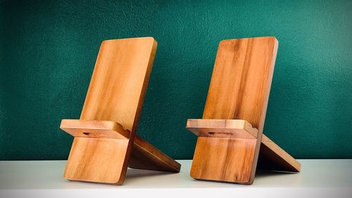 Empty chairs and table against wall