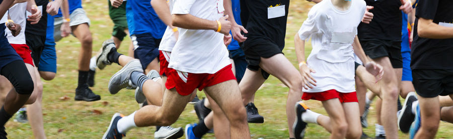 Group of people running on field