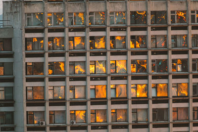 Very beautiful sunset is reflected in the window of an old house.