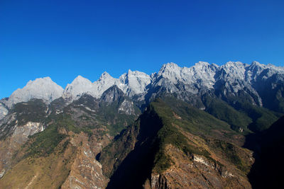 Low angle view of mountains against clear blue sky