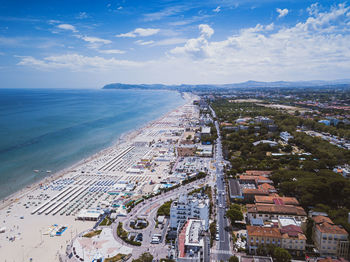 High angle view of buildings by sea against sky