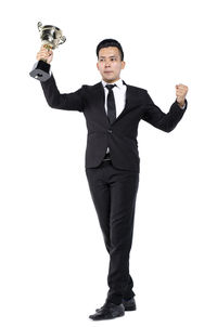 Portrait of young man standing against white background