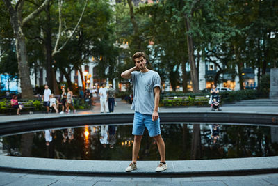 Full length of man standing on road in city