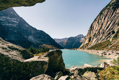 Scenic view of lake and mountains against clear sky