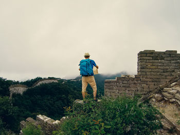 Rear view of man standing against sky