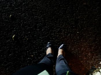 Low section of woman standing on tiled floor