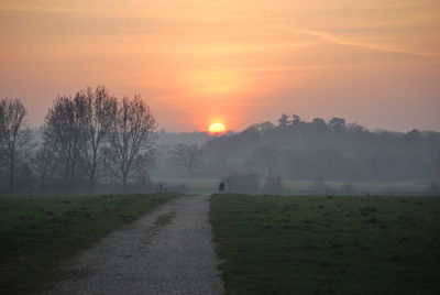 Scenic view of field against sky during sunset