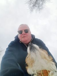 Portrait of man wearing sunglasses against sky