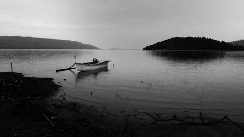 Boat sailing in lake against sky