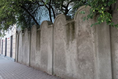 Stone wall in park by building
