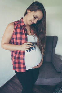 Pregnant woman standing at home