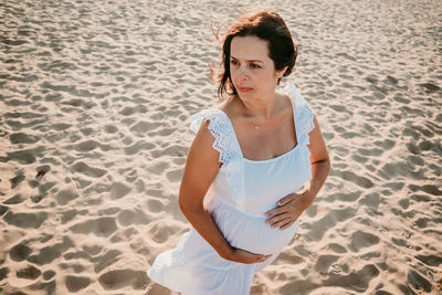 High angle view of woman standing on beach