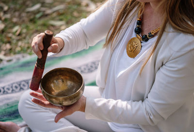 Unrecognizable woman with tibetan singing bowl for yoga and meditation
