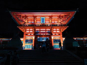 Low angle view of illuminated staircase by building at night