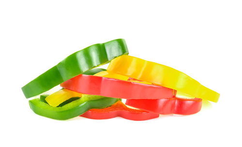 Close-up of multi colored bell pepper against white background