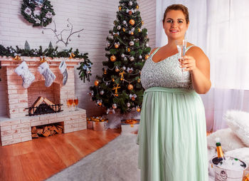 Full length of woman on christmas tree