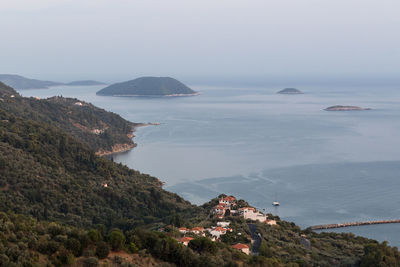 High angle view of sea and mountains against sky