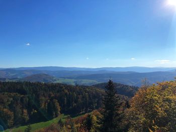 Scenic view of landscape against blue sky