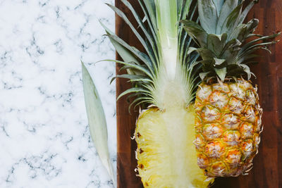 Directly above shot of halved pineapple on cutting board