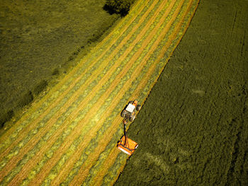Agricultural field witn tractor aerial drone view in springtime