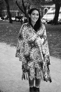 Portrait of young woman with shawl standing at park