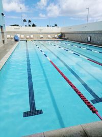 View of swimming pool against blue sky