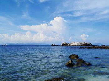 Scenic view of calm sea against cloudy sky