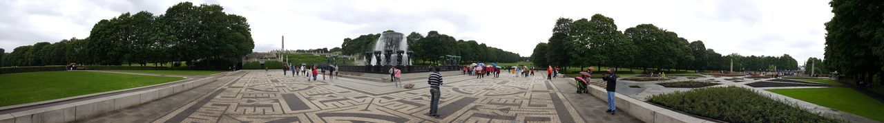 Panoramic view of people in park against sky