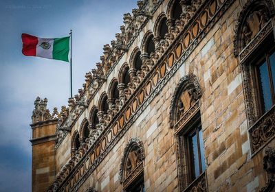 Low angle view of flag against sky