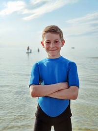 Portrait of boy standing in sea