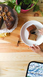 High angle view of hand holding food on table