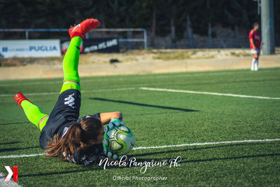 People playing soccer ball on grass