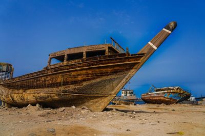 Old rusty ship against blue sky