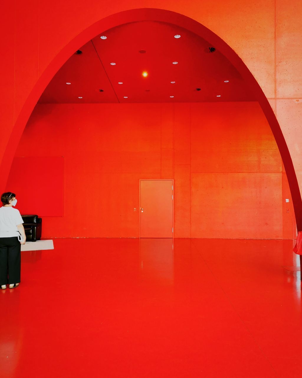LOW ANGLE VIEW OF ILLUMINATED RED WALL AND LIGHT