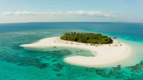 Sandy beach and tropical island by atoll with coral reef. patawan island with sandy beach. 