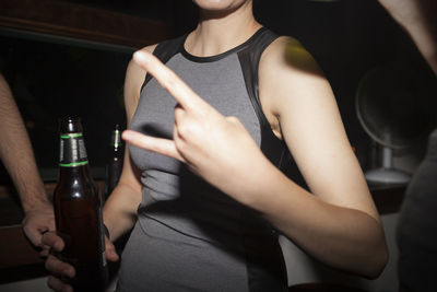 Young woman enjoying a beer at a party