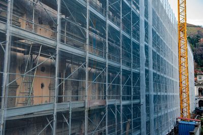 Low angle view of glass building at construction site