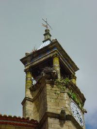 Low angle view of statue against building against clear sky