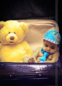 Portrait of cute baby girl with toy at home