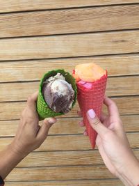 Cropped hands of man and woman holding ice cream cones