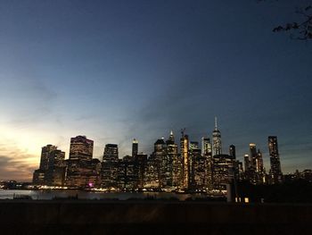 Illuminated buildings in city at dusk