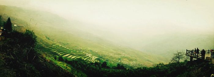 Scenic view of landscape against sky during foggy weather