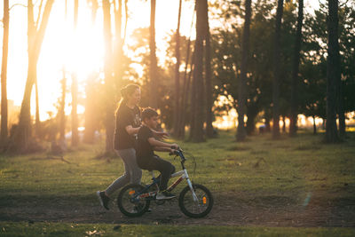 Mother and son excercising during sunset