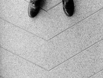 Low section of man standing on floor