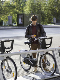 Man rents bicycle by smartphone application.eco-friendly urban transport for rent.healthy lifestyle.