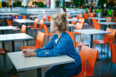 Woman sitting on chair in supermarket