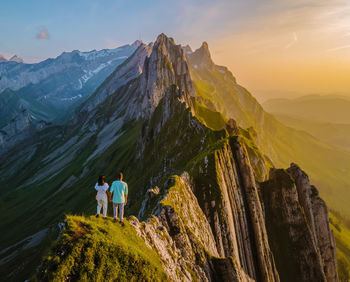 Rear view of man standing on mountain