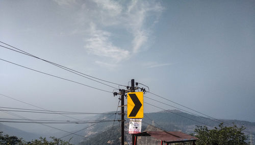 Low angle view of telephone pole against sky