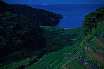 High angle view of trees and sea against sky