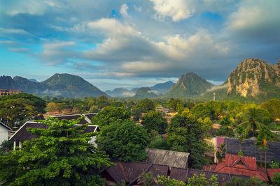 Scenic view of trees and mountains against sky